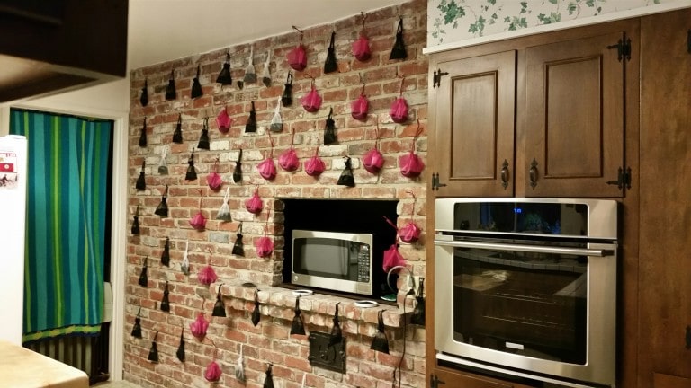 A photo of Pure NonScents Sachets hanging on the kitchen wall. This product removes smoke odors.