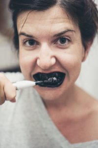 brushing with charcoal toothpaste